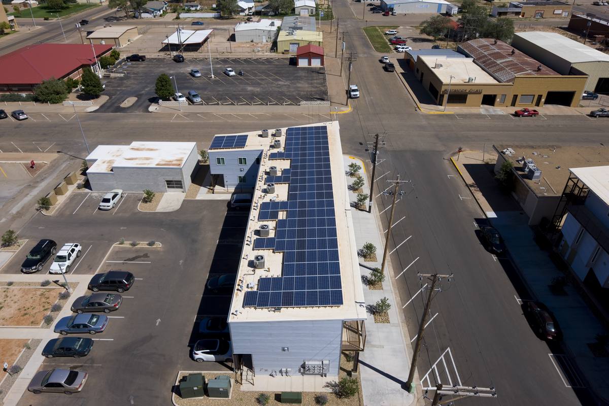 Aerial view of Hotel Clovis Lofts showing the rooftop solar panels and downtown Clovis