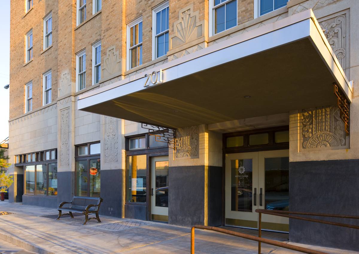 The main entrance at 201 N. Main Street with its canopy, benches, and carved stone reliefs